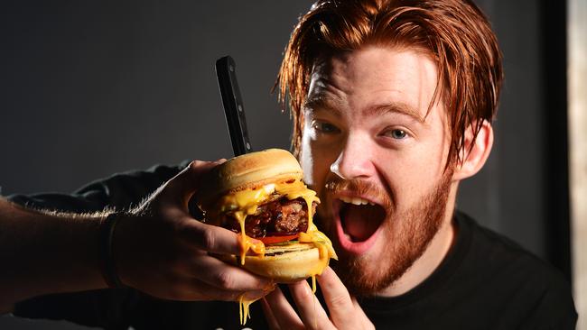 Jack McLeod eats a 'Bogan Burger' from Real Burger Co. Picture: Zak Simmonds