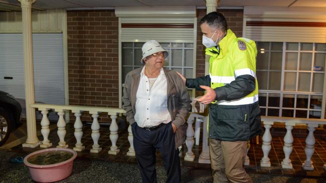 Mr Malinauskas reassures a man after whose wife is being taken to hospital. Picture: Brenton Edwards