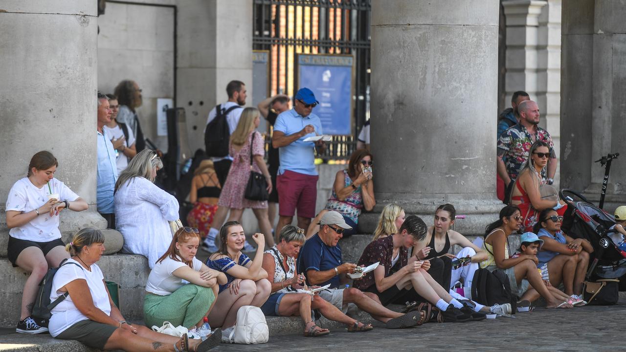 People are seen relaxing in Covent Garden in London. Picture: Peter Summers/Getty Images