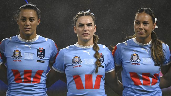 Jakiya Whitfeld will be fighting English international Fran Goldthorp for the Cowboys’ No.1 jersey. (L-R) Corban Baxter, Jakiya Whitfeld and Taliah Fuimaono of the Blues sing the national anthem before game three of the 2024 Women's State of Origin. (Photo by Ian Hitchcock/Getty Images)