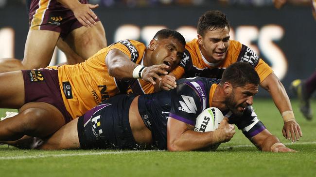 Tevita Pangai Jr and Kodi Nikorima fail to stop Jesse Bromwich from scoring. Picture: AAP Image/Daniel Pockett