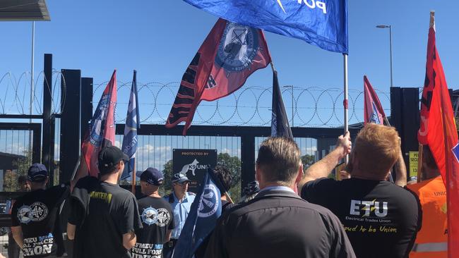  Union members protest outside the Rouse Hill Tallawong Sydney Metro station. 