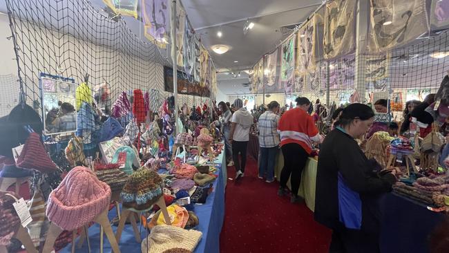 A wide view of attendees trying on the products at the 2023 Alice Springs Beanie Festival. Picture: Laura Hooper.