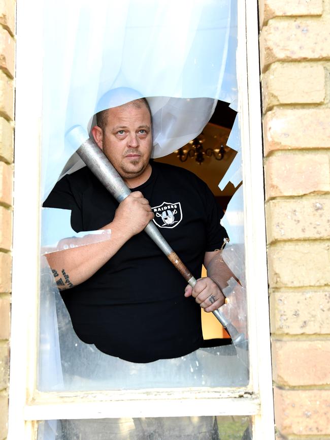 Werribee resident Jeremy Lynch armed himself with a baseball bat to protect his family after a huge rock was thrown through his window smashing his television. Picture: Nicole Garmston