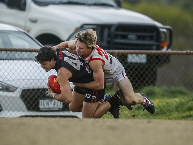 Frankston Bomber Jason Kingsbury is tackled by his Sorrento opponent.