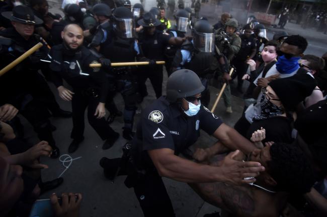 Police officers and protesters clash near CNN in Atlanta. Picture: AP