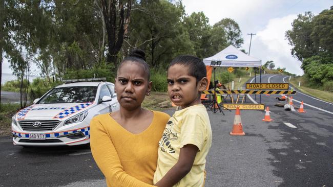 Yarrabah resident Keisha Dangar, 31, with son Drew, at the roadblock outside the Yarrabah indigenous community south of Cairns. The town was locked down to defend against coronavirus. Picture: Brian Cassey