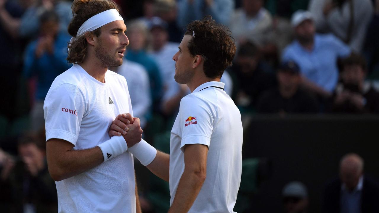 Tsitsipas and Thiem meet at the net after their epic. Picture: Daniel Leal/AFP