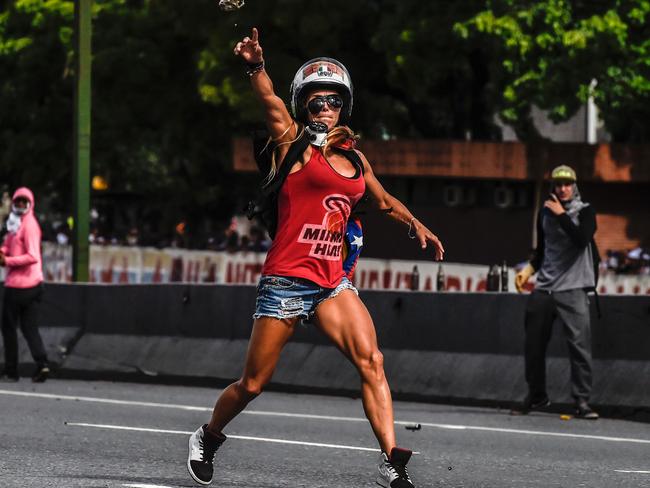 Opposition activist Caterina Ciarcelluti clashes with the police during a march against the Venezuelan President last month. Picture: Juan Barreto/AFP