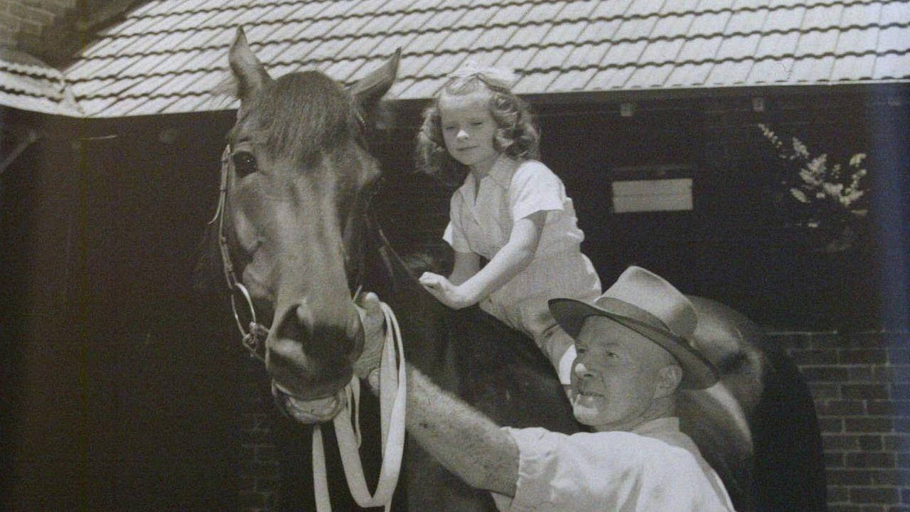 Racehorse trainer TJ Smith with daughter Gai (now Waterhouse) as a young girl sitting on racehorse 'Tulloch' in undated photo that hangs in the 'Tommy Smith Room' at Tulloch Lodge Stables, Kensington, adjacent to Randwick Racecourse in Sydney, 29/12/2003.