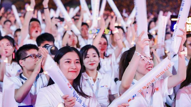 Alibaba employees cheer during an event to mark the 20th anniversary of the company. Picture: AFP