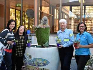 Michelle Coats and Dani Harrison from Rio Tinto, Lynn Lapham from Boyne Smelters Limited and artist Katrina Elliott next to the sculpture. Picture: Jessica Perkins