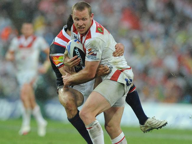 Dragons captain Ben Hornby is tackled by the Sydney Roosters' Anthony Minichiello. AAP Image/Dan Himbrechts