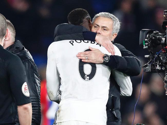 Manchester United's Portuguese manager Jose Mourinho (R) hugs Paul Pogba.