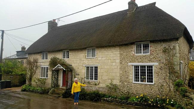 Coast resident Gwenda Tudman inspects a home in the English village of Cattistock during filming of an episode of Escape to the Country. Picture: Contributed