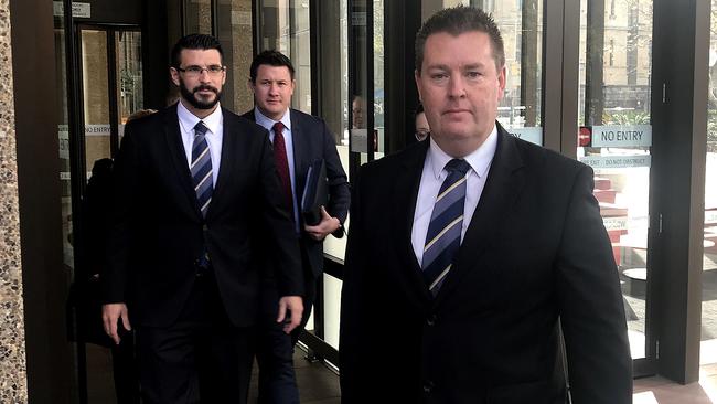 Officer in charge Sergeant Darren Gunn (far right) and detectives leave the NSW Supreme Court in Sydney after DanielHoldom pleaded guilty. Picture: Emma Partridge