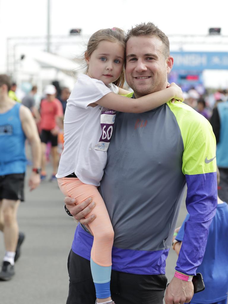 Jai Cave and daughter Olivia at the finish of the Two Kilometre Junior Dash. Picture: Tim Marsden.