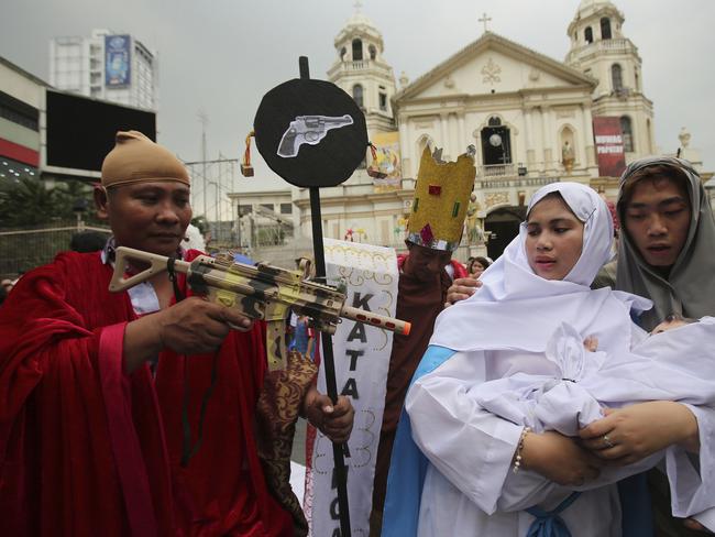Filipino protesters perform during a Christmas-theme street play to protest alleged extra judicial killings in Manila. Picture: AP