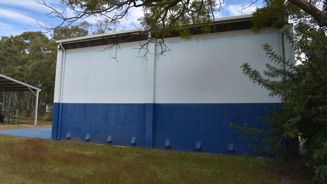 The squash courts building next to the pool.