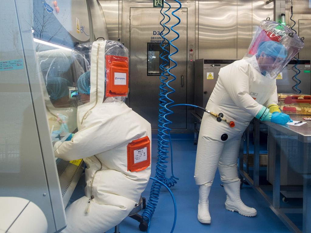 A 2017 photograph shows workers next to a cage with mice inside the P4 laboratory in Wuhan, the capital of China's Hubei province. Picture: Johannes Eisele/AFP