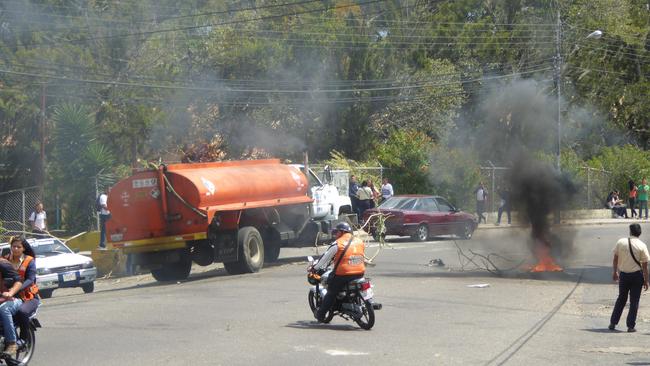 Locals engage in fiery protests on the streets. Picture: Will Hatton