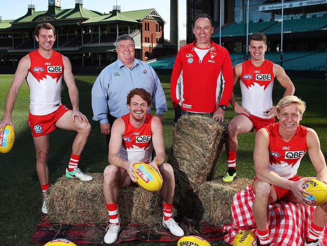 Swans Harry Cunningham, Gary Rohan, Tom Papley, Isaac Heeney, along with coach John Longmire, pose with co-founder of Buy A Bale Charles Alder. Picture. Phil Hillyard