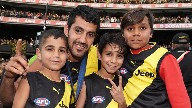 Marlion Pickett celebrates the win with his children after the 2019 AFL grand final in which his Richmond Tigers beat the GWS Giants. Picture: Michael Dodge/AAP