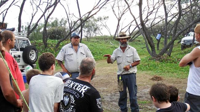 STAY SAFE: Fraser Island rangers delivering dingo-safe messaging to campers.