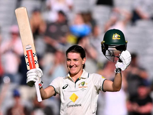 Australia's Annabel Sutherland celebrates scoring her century during the second day of the Women's Ashes cricket Test match between Australia and England at the Melbourne Cricket Ground (MCG) in Melbourne on January 31, 2025. (Photo by William WEST / AFP) / --IMAGE RESTRICTED TO EDITORIAL USE - STRICTLY NO COMMERCIAL USE--