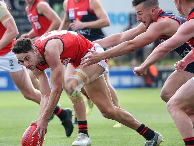 VFL Preliminary Final: Casey Demons v Essendon at North Port Oval , Port Melbourne. James Munro of Melbourne tackles Bruno Laguda. Picture : Ian Currie