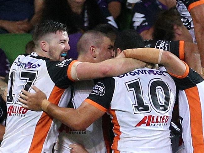 The Tigers celebrate a late try during the Round 2 NRL match between the Melbourne Storm and the Wests Tigers at AAMI Park in Melbourne, Saturday, March 17, 2018. (AAP Image/Hamish Blair) NO ARCHIVING, EDITORIAL USE ONLY