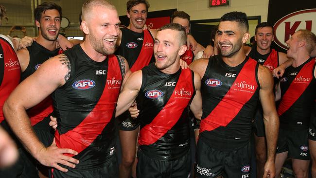 Essendon’s big-name recruits Jake Stringer, Devon Smith and Adam Saad sing the song after the win. Picture: Michael Klein