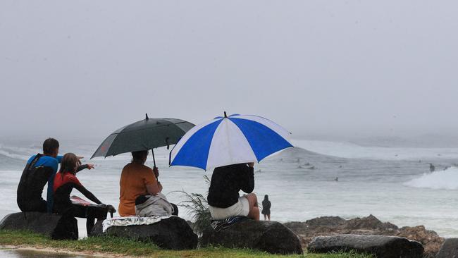 People watch on as surfers take to the waves at Snapper Rocks on Monday. Picture: Scott Powick/NCA News Wire