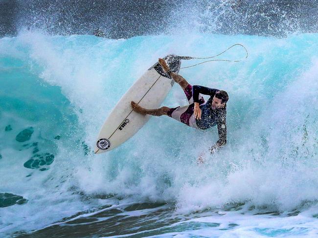 A surfer takes advantage of huge seas at Snapper Rocks on the Gold Coast. Picture: Nigel Hallett