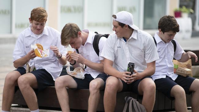 Schoolboys take a break for lunch outside Tony Abbott’s office in Manly.