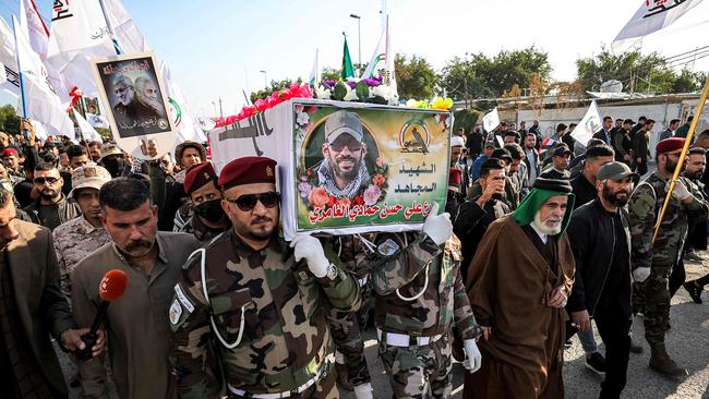 Members of the group Kataeb Hezbollah, one of the factions of Iraq's Hashed al-Shaabi (Popular Mobilisation Forces - PMF) paramilitaries, carry the body of their fallen comrade Hassan Hammadi al-Amiri after he was killed in a US airstrike. Picture: AFP.