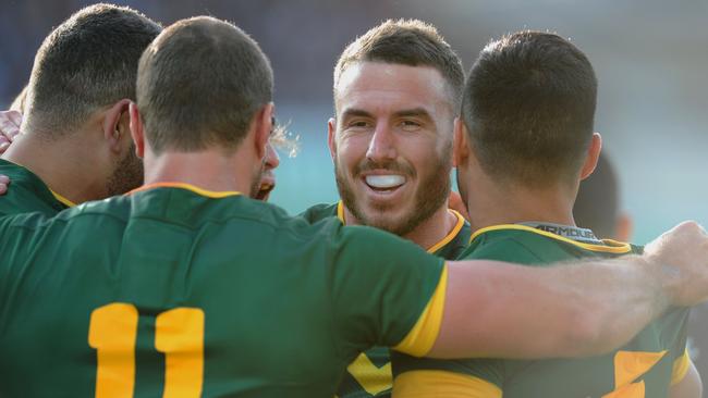 Australia's Darius Boyd (2nd-R) celebrates with teammates after scoring the first try during the Rugby League Test between Australia and New Zealand in Perth on October 15, 2016. / AFP PHOTO / Greg Wood / IMAGE RESTRICTED TO EDITORIAL USE — NO COMMERCIAL USE