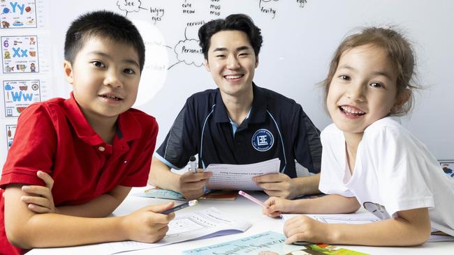 E-Yong Lee from Lee Excellence Education Academy with students Owen Gu and Emily Paterson. Picture: Richard Walker