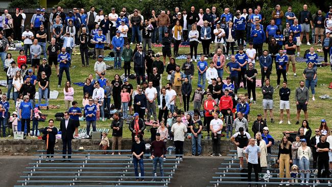 SYDNEY, AUSTRALIA - NewsWire Photos APRIL, 17, 2021: Spectators are seen standing for a minute's remembrance during Tommy Day, a celebration of former Newcastle Jets player Tommy Raudonikis, at Henson Park in Sydney. Picture: NCA NewsWire/Bianca De Marchi