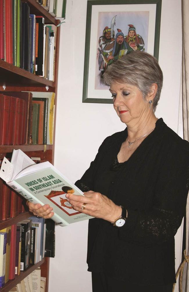 Virginia Hooker reading a book she coedited with Professor Greg Fealy called <i>Voices of Islam in Southeast Asia</i>. Picture: Paul Cockram