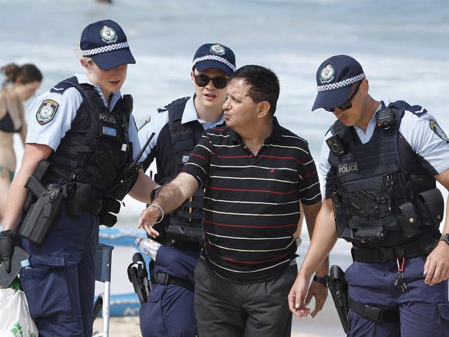 SYDNEY, AUSTRALIA - NewsWire Photos JANUARY 26, 2025: Police escort a man off the beach at Bronte Beach on Australia day.Picture: NewsWire / Damian Shaw