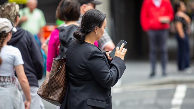 SYDNEY, AUSTRALIA - NewsWire Photos February 06, 2024: A generic photograph of people on their phone in Sydney. Picture: NCA NewsWire / Christian Gilles