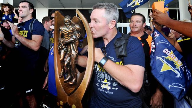 The North Queensland Cowboys return to Townsville after their grand final win in Sydney Coach Paul Green kisses the trophy