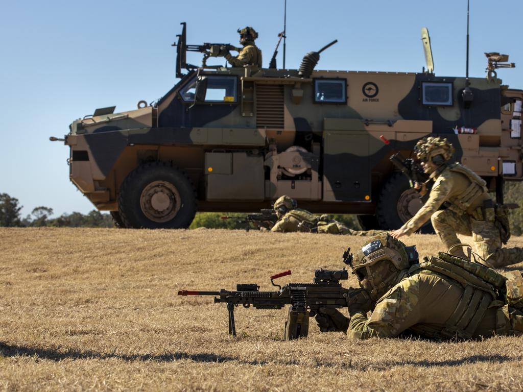 Aviators from No. 2 Security Forces Squadron dismount from a Bushmaster Protected Mobility Vehicle (PMV) during Exercise Nomad Walk at RAAF Base Amberley, Qld.