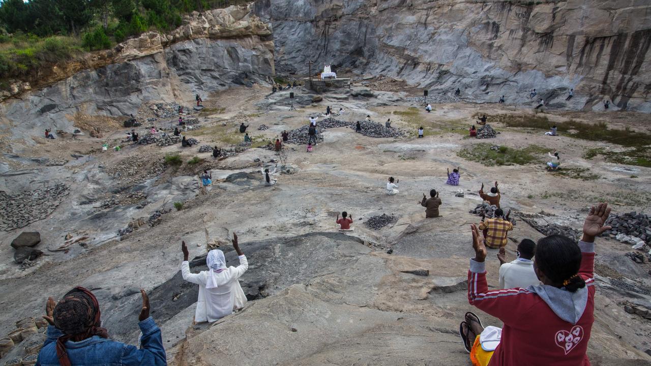 Father Pedro, founder of the Akamasoa association, conducts the traditional great mass celebrating Easter in a granite quarry in Antananarivo, Madagascar following social distancing practices. Picture: AFP