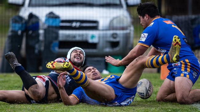 JohnRyan dives for the corner but is smashed by a try saving tackle from Kangaroos halfback Alex Seve. News Local, Pictures by Julian Andrews.