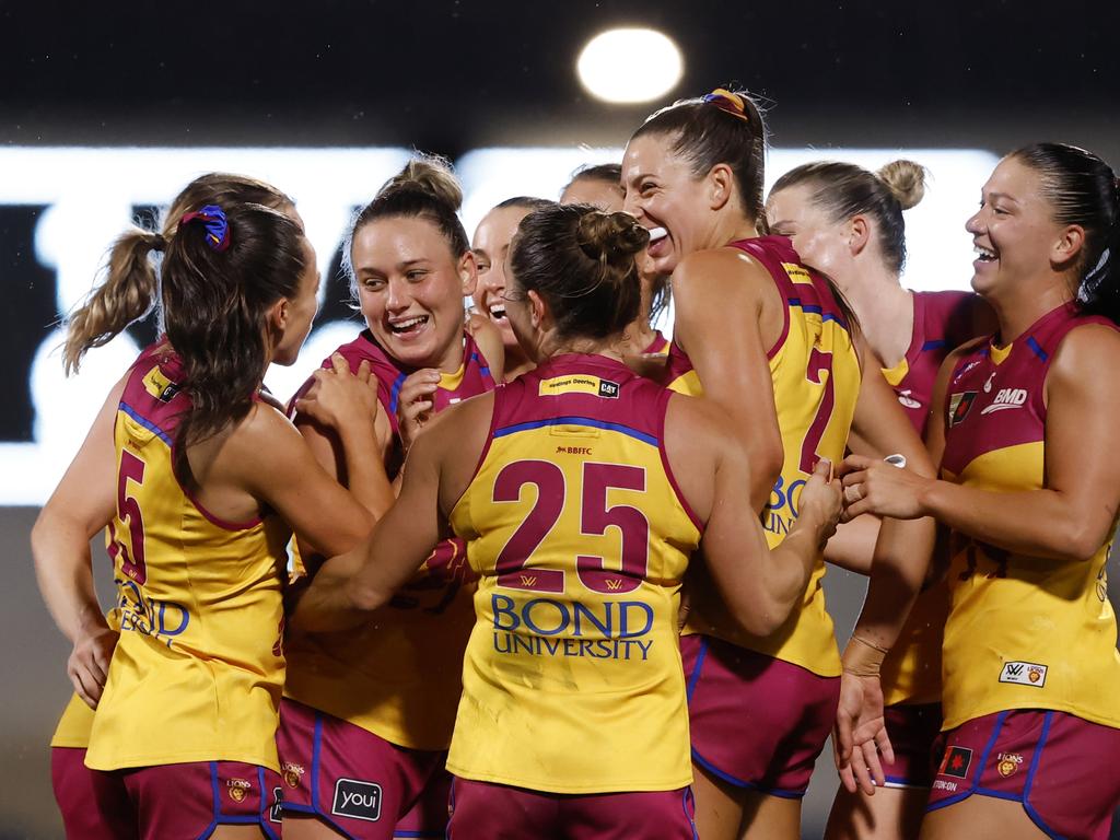 Ellie Hampson is mobbed by teammates after kicking a goal. Picture: Darrian Traynor/Getty Images