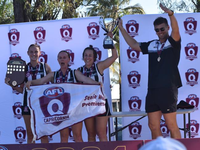 Rockhampton Panthers' co-captains Laila Howard, Amy Mill and Hayley Richmond and coach Jesse Johnston celebrate the team's grand final win.