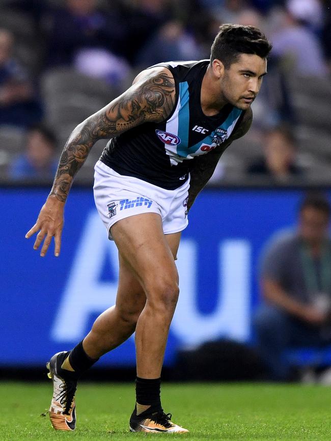 Chad Wingard limps to the bench after straining his hamstring against North Melbourne. Picture: AAP Image/Joe Castro