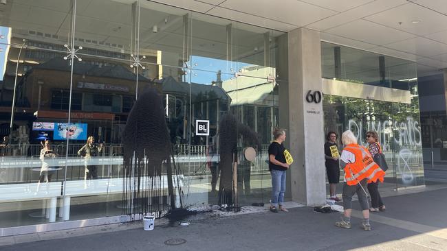 Rebels have covered the windows of the building in black paint. Picture: Isabel McMillan